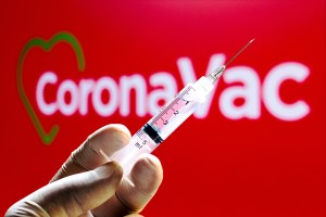 BRAZIL - 2020/11/10: In this photo illustration a medical syringe seen with CoronaVac logo displayed in the background. Sinovac and Butantan Institute are testing the vaccine in Brazil. (Photo Illustration by Rafael Henrique/SOPA Images/LightRocket via Getty Images)